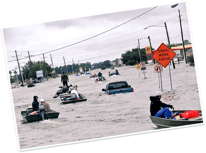 Image of the Executive Director Derrian evacuating by boat after hurricane Harvey hit Beaumont, TX