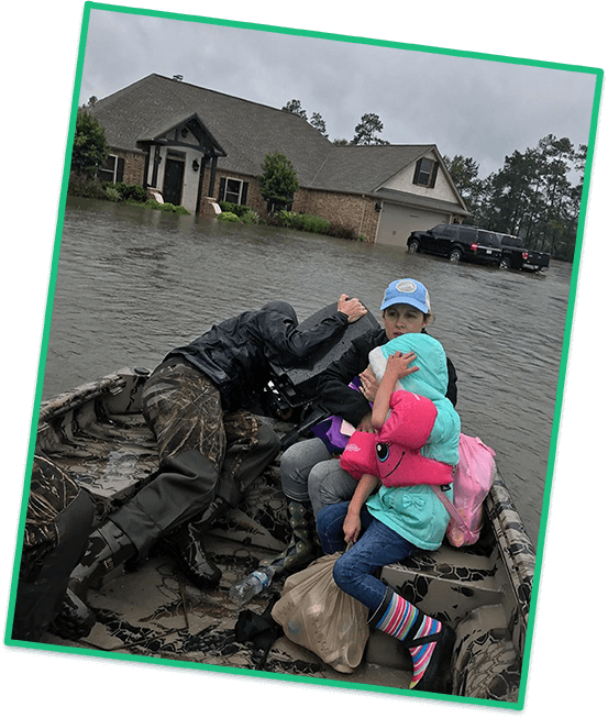 Image of Kyle and his family evacuating by boat after hurricane Harvey hit Beaumont, TX